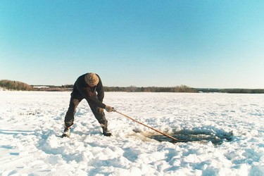 Elder Kerry Prosper, spearing eels through the ice.