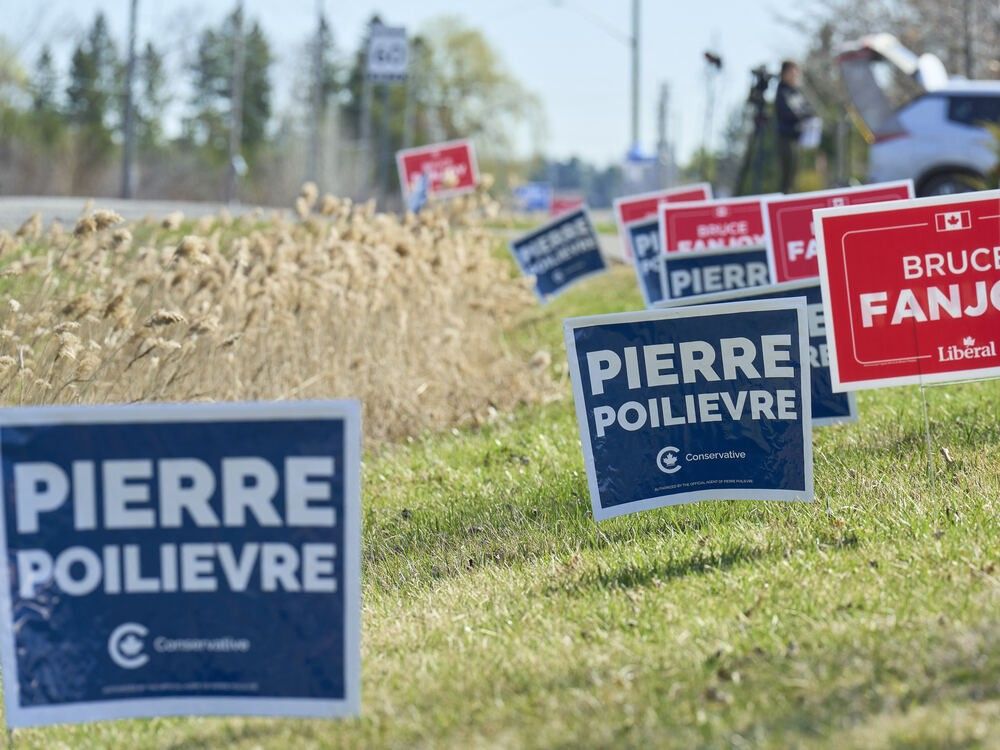 Lawn signs for Conservative leader Pierre Poilievre and Bruce Fanjoy, Liberal candidate for House of Commons in the riding of Carleton, sit across from a polling station in Ottawa, Ontario on April 28, 2025. Lawn signs for Conservative leader Pierre Poilievre and Bruce Fanjoy, Liberal candidate for House of Commons in the riding of Carleton, sit across from a polling station in Ottawa, Ontario on April 28, 2025.