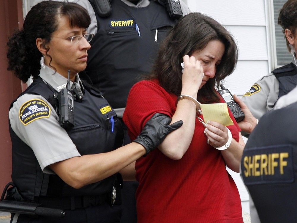  Penny Boudreau is led from court in Bridgewater, N.S., in June 2008, after her appearance in the murder of her 12-year-old daughter, Karissa Boudreau.