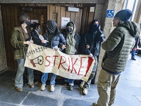 Students hold a sign that says strike