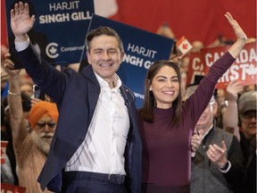 Pierre and Anaida Poilievre wave to the crowd at a rally