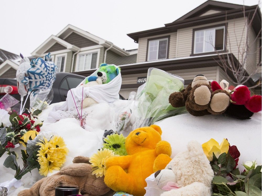  A memorial is seen for seven members of a family slain outside of their former home at 180A Avenue and 83 Street in Edmonton, Alta., on Thursday, Jan. 1, 2015.