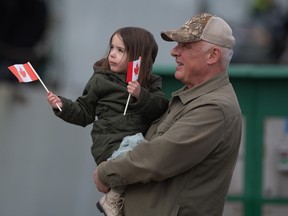 A girl waves a Canadian flag
