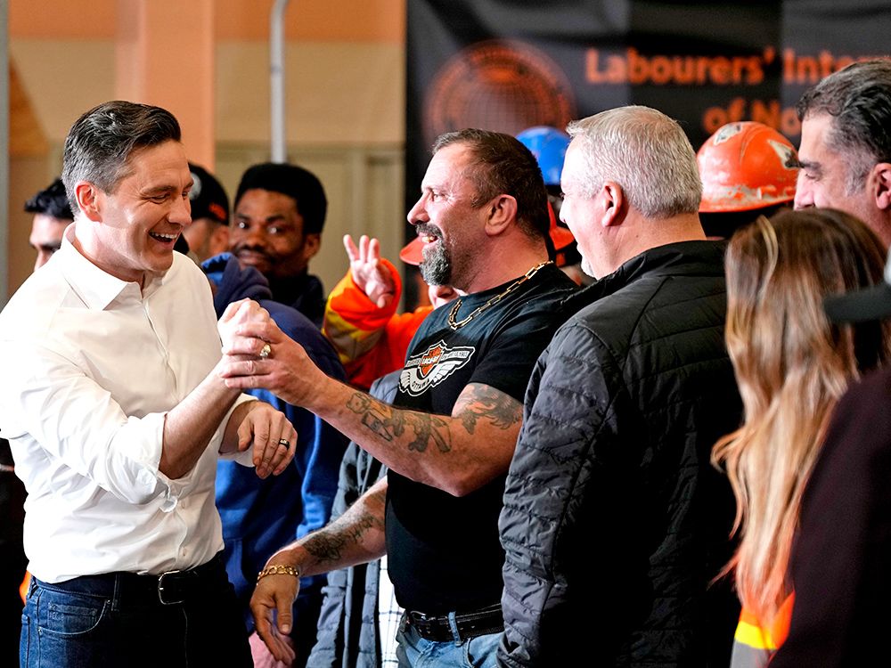  Conservative Party Leader Pierre Poilievre jokes with union members as he heads to the lectern to speak at a pre-election event, at a Labourers’ Union training centre in Ottawa, on Friday, March 21, 2025.
