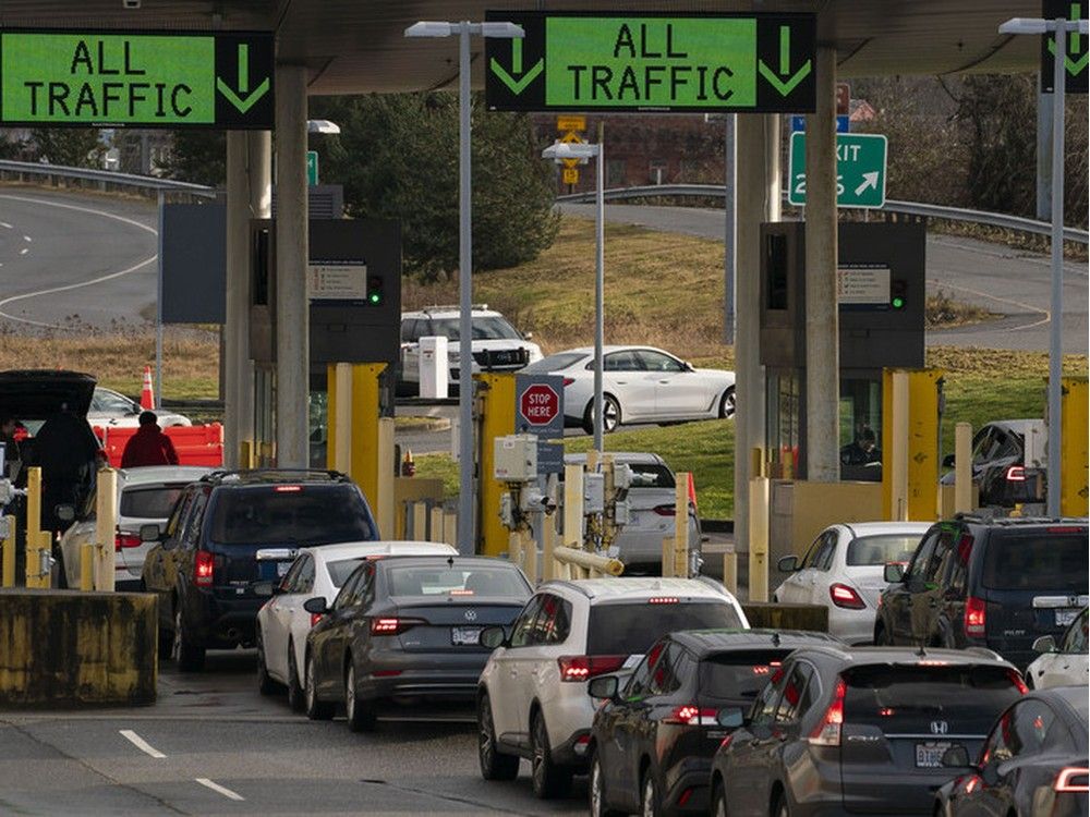  Vehicles enter the United States from Canada at the Peace Arch border crossing on February 1, 2025 in Blaine, Washington.