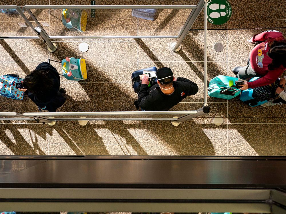 Travellers wait in line for security screening at Seattle-Tacoma International Airport, one of the locations visited by a Canadian resident with measles. Travellers wait in line for security screening at Seattle-Tacoma International Airport, one of the locations visited by a Canadian resident with measles.