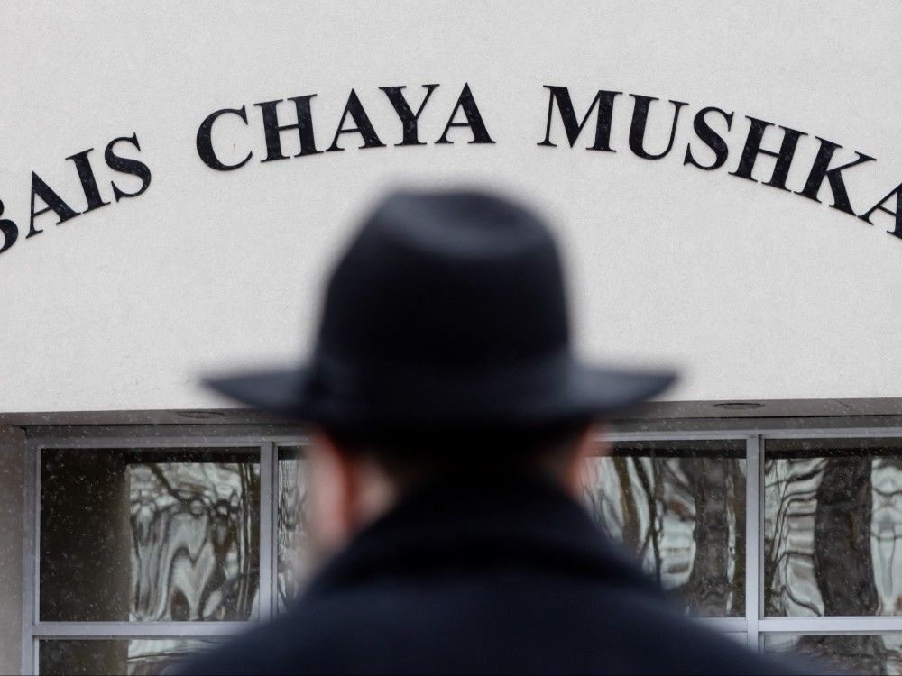 A Rabbi walks toward the Bais Chaya Mushka Girls Elementary School in Toronto’s North York, which was shot at for a third time, on Friday, Dec. 20, 2024. 