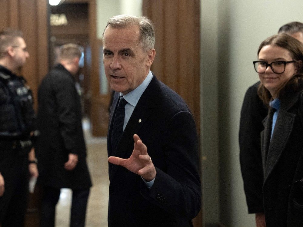 Liberal leader Mark Carney speaks briefly with media before making his way to caucus meeting on Monday, March 10, 2025 in Ottawa.