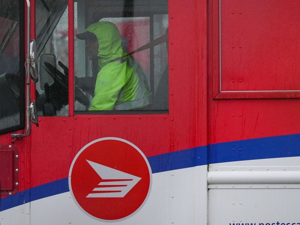 A Canada Post employee drives a mail truck at a delivery depot in Vancouver, B.C., Tuesday, Dec. 17, 2024. A Canada Post employee drives a mail truck at a delivery depot in Vancouver, B.C., Tuesday, Dec. 17, 2024.
