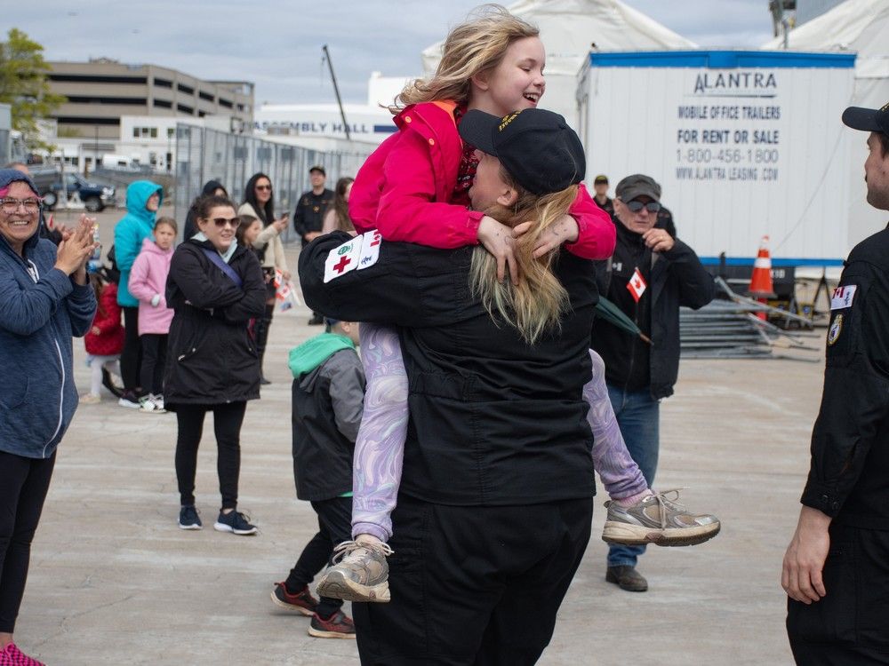 Ruby Osborne, 9, jumps into her mom, Master Corporal Bailey Osborne's arms, after HMCS Margaret Brooke arrived back in Halifax on Friday, May 9, 2025.