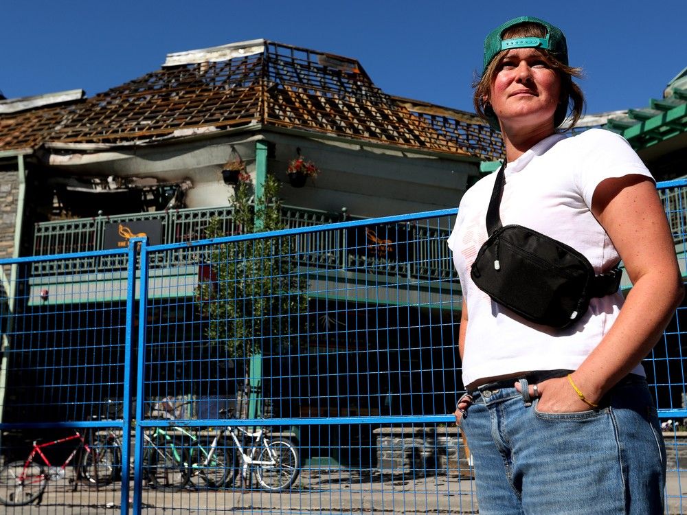  Rachel Bailey, co-owner of the Peacock restaurant, poses for a photo in downtown Jasper, Monday, Aug. 19, 2024. Bailey’s restaurant (pictured top left) and home were both destroyed by wildfire.