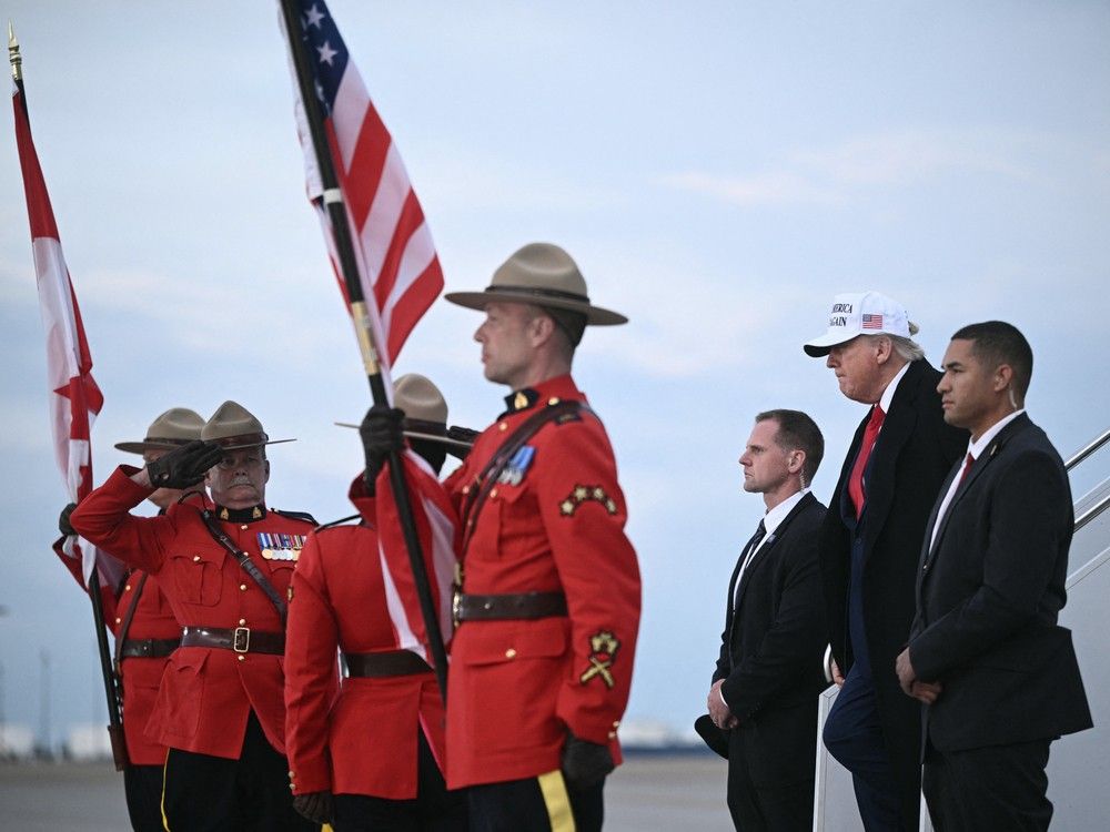 US President Donald Trump steps off of Air Force One upon arrival at Calgary International Airport, before the start of the G7 summit, in Calgary, Alberta, Canada, June 15, 2025.