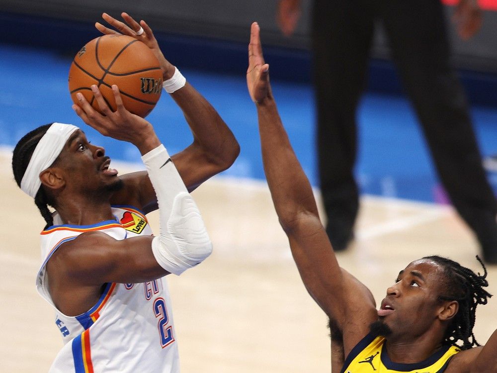   Shai Gilgeous-Alexander shoots over Aaron Nesmith during Game 5 of the 2025 NBA Finals on Monday night.