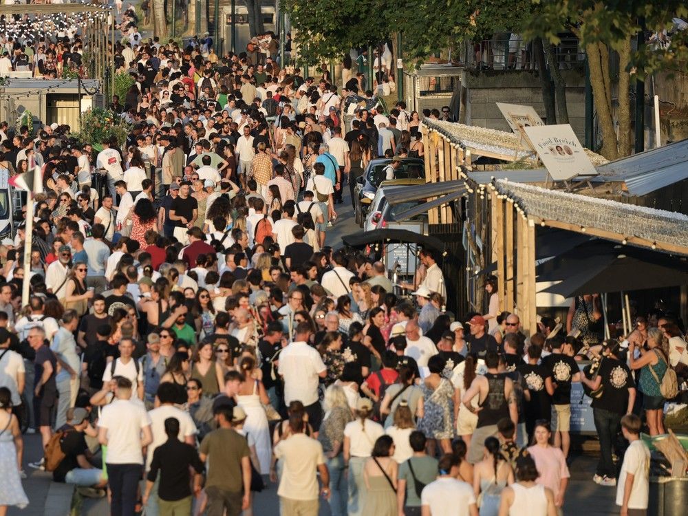  Music enthusiasts gather for free concerts on the banks of the Seine river during France’s annual street music festival, the Fete de la Musique, in Paris on June 21, 2025.