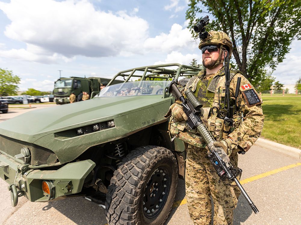  Princess Patricia’s Light Infantry Cpl. Kevin Jackowski stands alongside a light tactical vehicle (LTV) following a press conference on security measures for the upcoming G7 summit in Kananaskis.