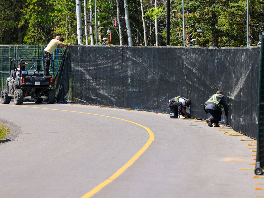  Black fabric is installed on security fencing around Kananaskis Village, the site of the 2025 G7 summit.