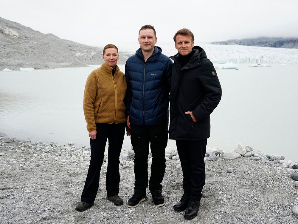  French President Emmanuel Macron, right, Danish Prime Minister Mette Frederiksen, left, and Greenlandic leader Jens-Frederik Nielsen at a glacier in Greenland, Sunday, June 15, 2025.
