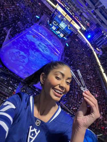 Shania Bhopa poses at a Toronto Maple Leafs game with her hormone injections.