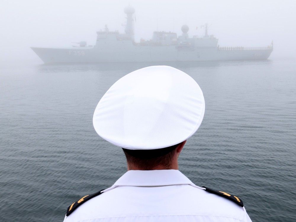  Royal Canadian Navy sailor first class, Bradley Downey, looks on through heavy fog at the arrival of the Danish warship, HDMS (Her Danish Majesty’s Ship) Vædderen (F359) during a sailpast at a ceremony marking the start of Fleet Week in Halifax Thursday June 19, 2025.