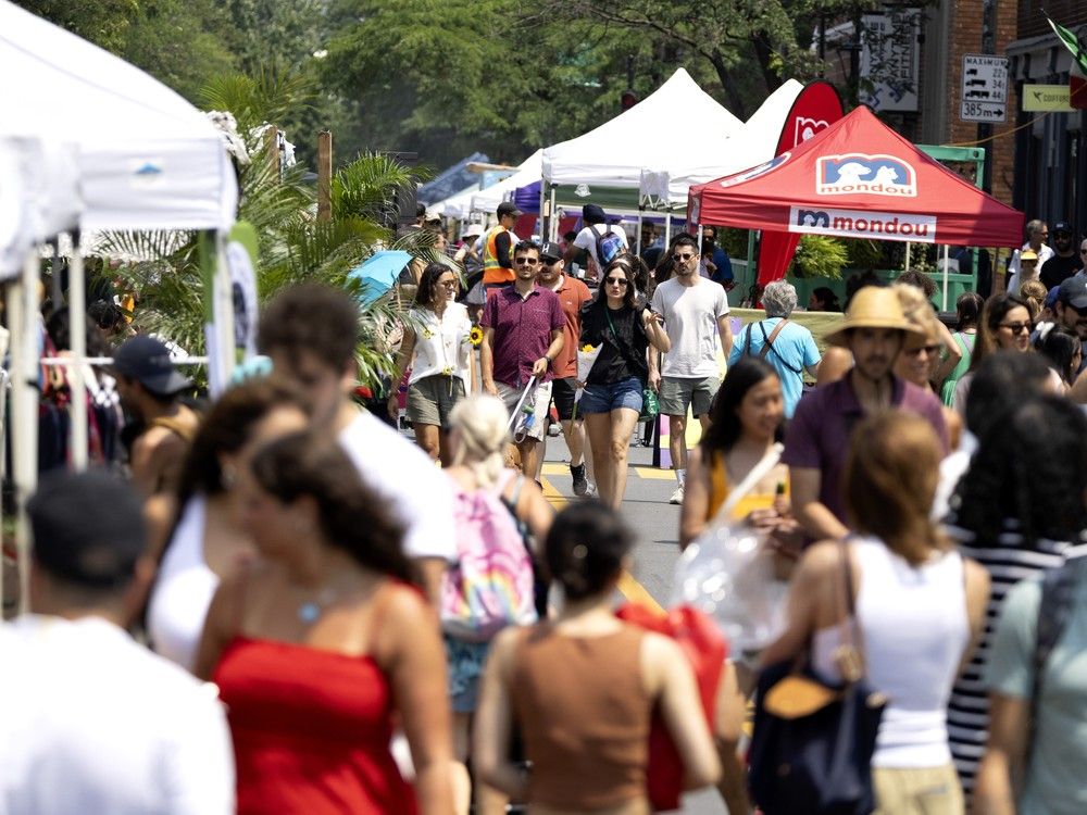  Despite the heat, people crowd Notre-Dame Street during the street fair in Little Burgundy in Montreal, on Sunday, July 13, 2025.