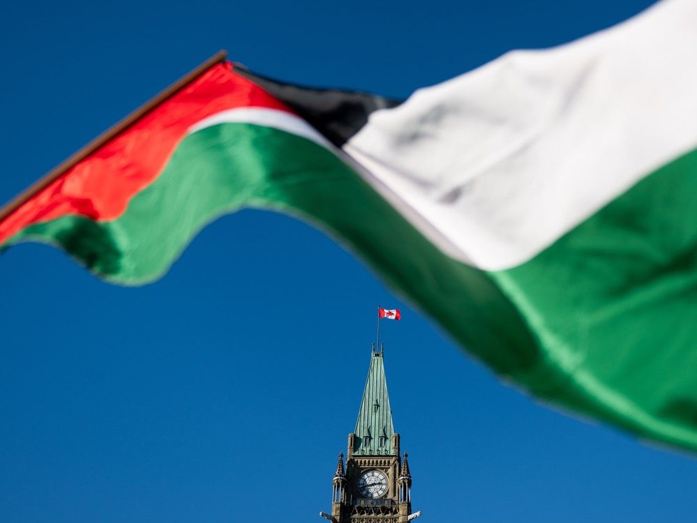 A Palestinian flag flies near the Peace Tower during a march for Gaza rally on Parliament Hill in Ottawa on Saturday, Nov. 4, 2023.