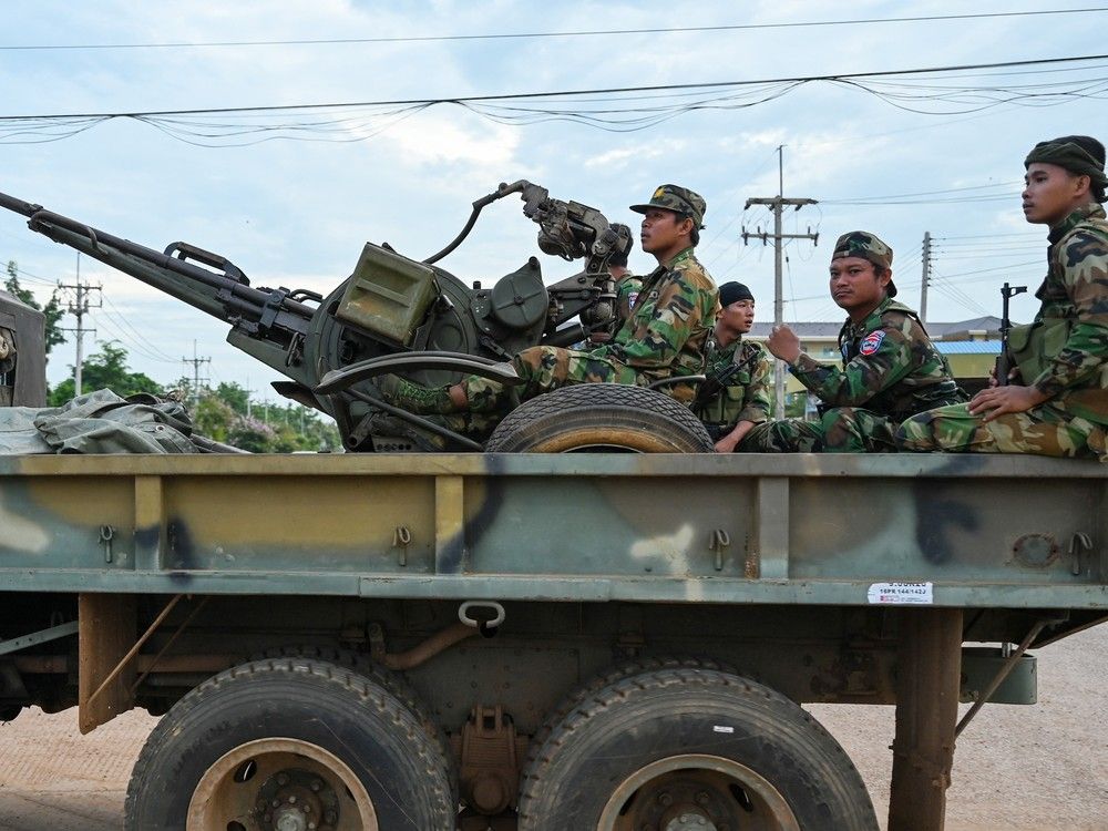  Cambodian soldiers stand on a military truck with an anti-aircraft gun in Oddar Meanchey province on July 25, 2025.