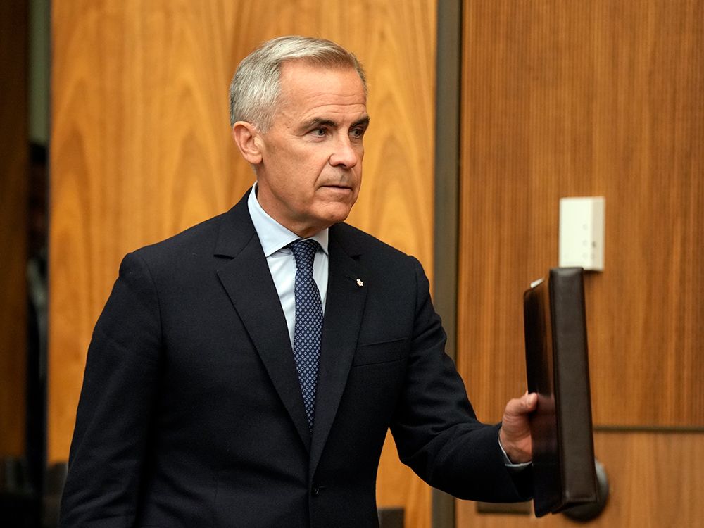 Prime Minister Mark Carney heads to the stage for a news conference on Canada recognizing the State of Palestine, in Ottawa on Wednesday, July 30, 2025.