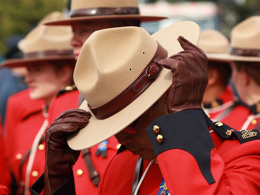 An RCMP officer adjusts his Stetson hat before the start of march.