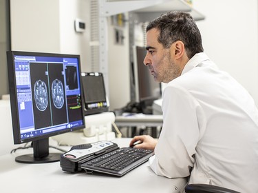 Dr. Nir Lipsman looks over a brain scan outside of a Focused Ultrasound Treatment Room, at Sunnybrook Health Sciences Centre. Toronto, Ont, June 12, 2025.