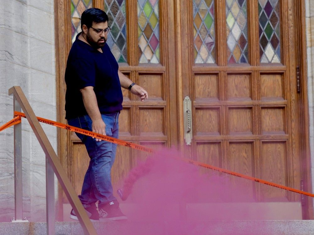 A church staff member throws out one of two smoke bombs that were set off inside Église MR during Sean Feucht’s performance on Friday, July 25, 202,5 in Montreal. A church staff member throws out one of two smoke bombs that were set off inside Église MR during Sean Feucht’s performance on Friday, July 25, 202,5 in Montreal.