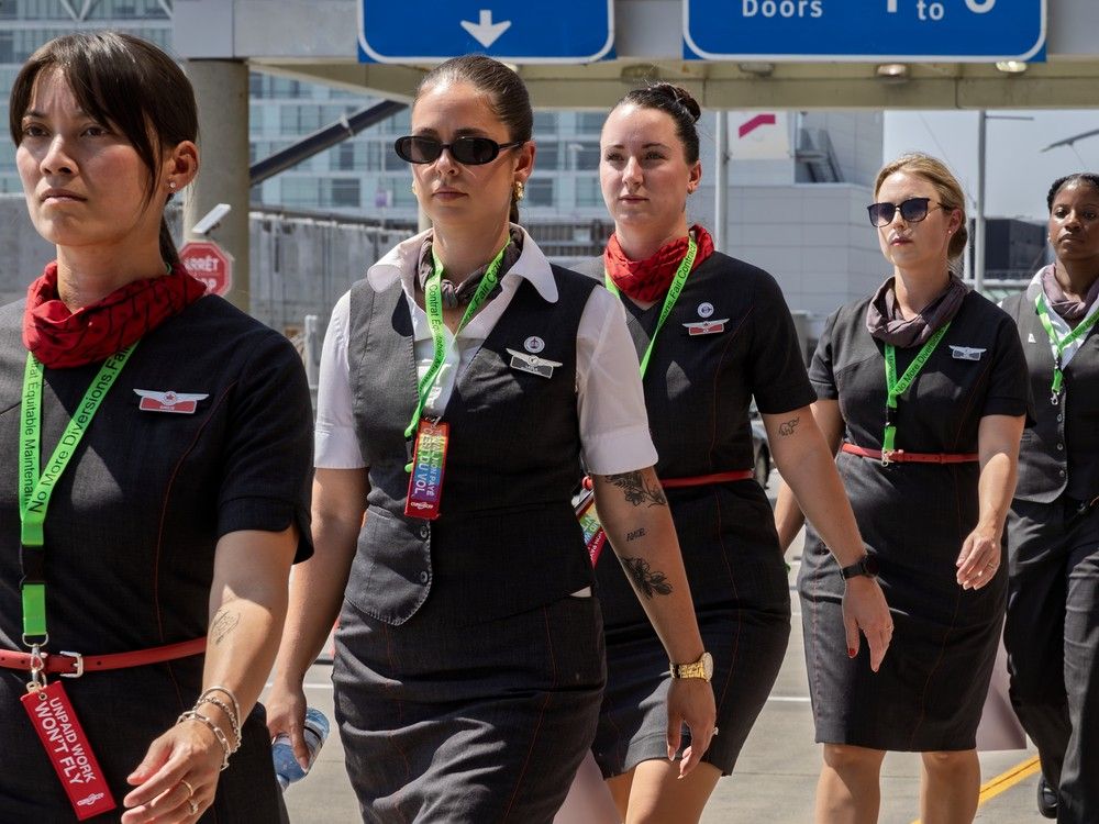  Air Canada flight attendants protest their wages and unpaid labour when working on a plane when it’s not in the air, at Trudeau Airport in Dorval on Monday, Aug. 11, 2025.