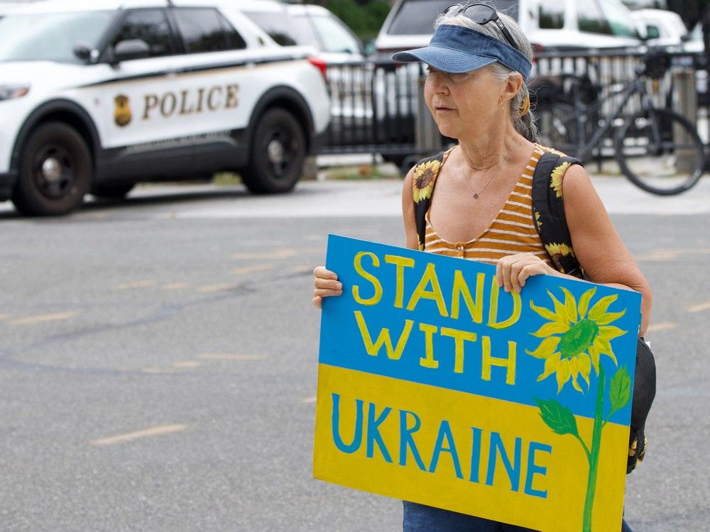 A supporter of Ukraine holds a placard near the White House ahead of the meeting between Ukrainian President Volodymyr Zelensky, European leaders and US President Donald Trump in Washington, DC, on August 18, 2025. European leaders join Ukrainian President Volodymyr Zelensky in talks with US President Donald Trump on August 18, as they try to find a way to end Russia's offensive. The leaders heading to Washington on Monday to appear alongside Zelensky call themselves the 