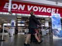 An Air Canada flight attendant walks through the terminal at Pierre-Elliott Trudeau Airport in Montreal on Aug. 19, when flights were slated to resume.