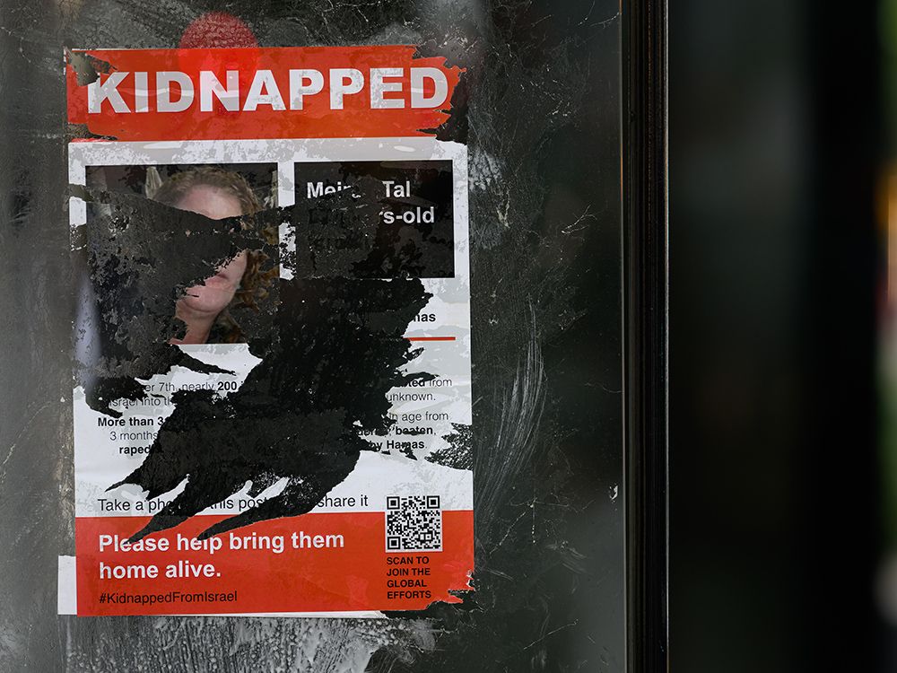  A vandalized poster calls for the release of Israeli hostages being held by Hamas, in London, England, 2023.