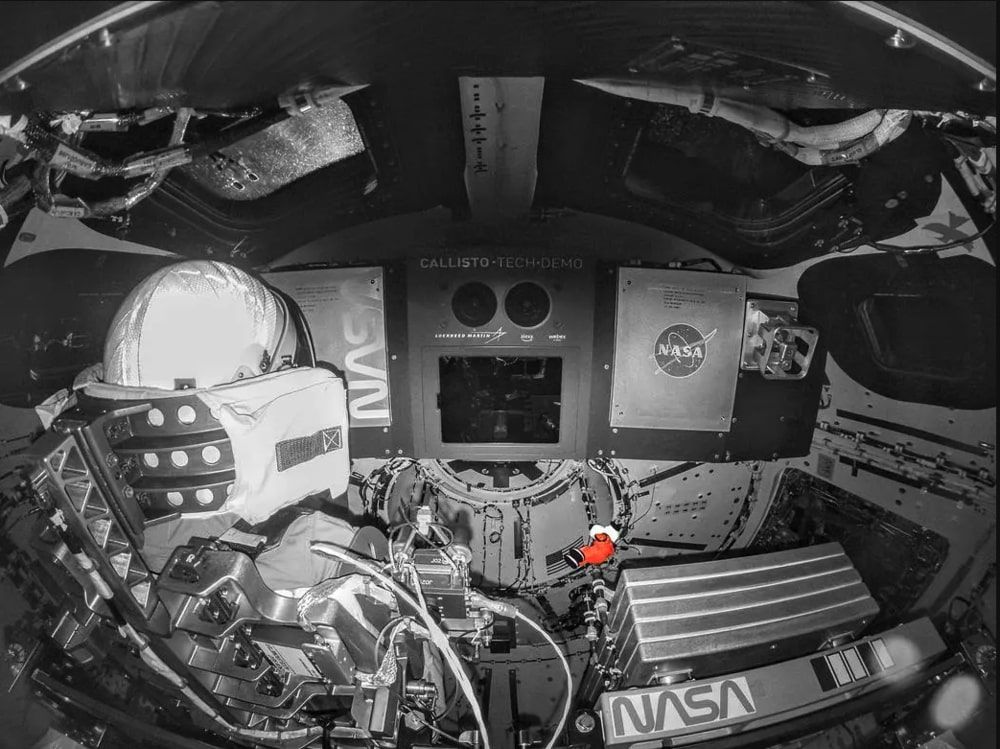  Snoopy, the zero-gravity indicator for NASA’s Artemis I flight test, floating in space on Nov. 20, 2022, while attached to his tether in the Orion spacecraft, next to a simulated astronaut.