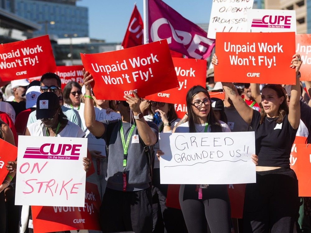 Air Canada flight attendants, bolstered by friends, families and other unions, picket along the departures lane of Calgary International Airport on Sunday, August 17, 2025. 