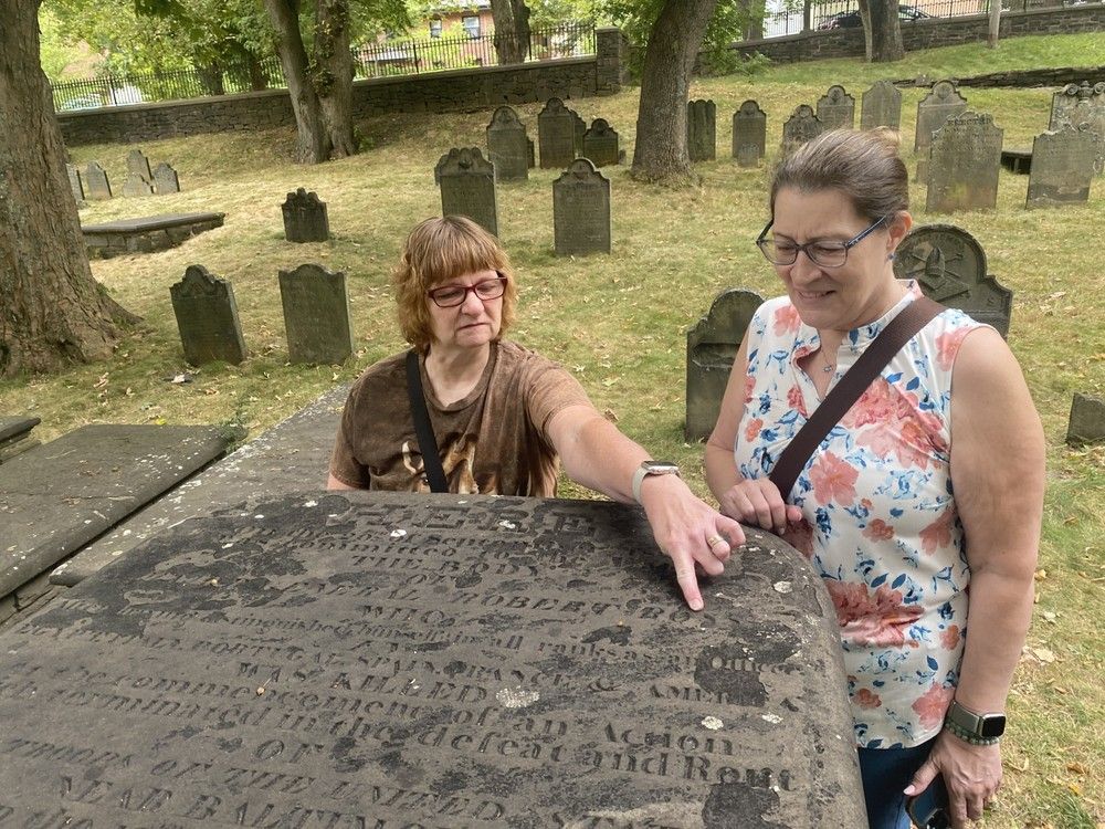  Jo-Anne Wilcox, left, and Jo-Ann Heikkila, both visiting Halifax from Toronto, examine the grave Monday of British General Robert Ross at the city’s Old Burying Ground. This week marks the 211th anniversary of Ross and his troops burning down the White House during the War of 1812.