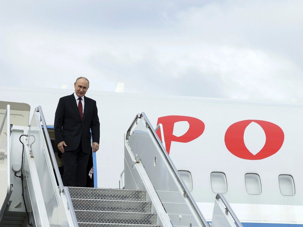 Russian President Vladimir Putin stands on the steps of the plane prior to departure at Joint Base Elmendorf-Richardson, Alaska, Friday, Aug. 15, 2025, after meeting with U.S. President Donald Trump.