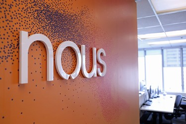 Nous logo and desks.