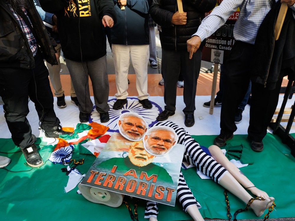  Sikh separatist activists with the Khalistan movement deface a placard and mannequin of Indian Prime Minister Narendra Modi as they protest outside the Consulate General of India in Toronto, Canada, October 18, 2024. Canada expelled six Indian diplomats including the high commissioner, linking them to the murder of a Sikh separatist leader and alleging a broader effort to target Indian dissidents.