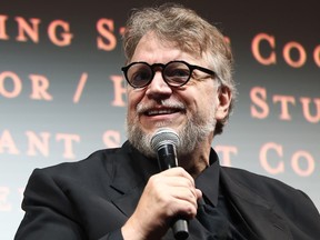 Guillermo del Toro with a microphone in his hand