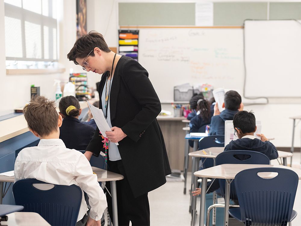 Teacher Catherine Gay is seen with Grade 5 students at the Calgary Classical Academy in a file photo from 2023. Charter schools like the Classical Academy are becoming increasingly popular with parents fed up with the public school system, writes Peter MacKinnon.