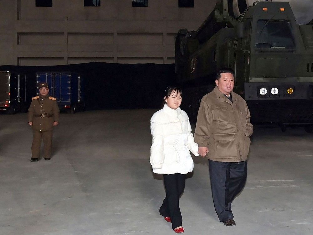  This picture taken on November 18, 2022 and released from North Korea’s official Korean Central News Agency (KCNA) on November 19, 2022 shows North Korea’s leader Kim Jong Un walking with his daughter as he inspects a new intercontinental ballistic missile.