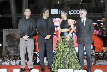  Leonardo DiCaprio, Benicio del Toro, Chase Infiniti, and Paul Thomas Anderson smile during the fan event for the movie One Battle After Another at Plaza Toreo Parque Central on September 18 in Naucalpan de Juarez, Mexico. Eloisa Sanchez/Getty Images