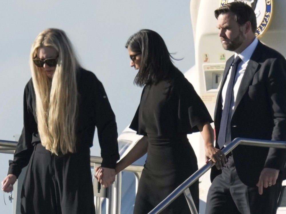  Vice President JD Vance, right, Second Lady Usha Vance, center, and Erika Kirk, holding a cross on a chain, deplane Air Force Two, carrying the body of Charlie Kirk, the CEO and co-founder of Turning Point USA who was shot and killed, Thursday, Sept. 11, 2025, in Phoenix.