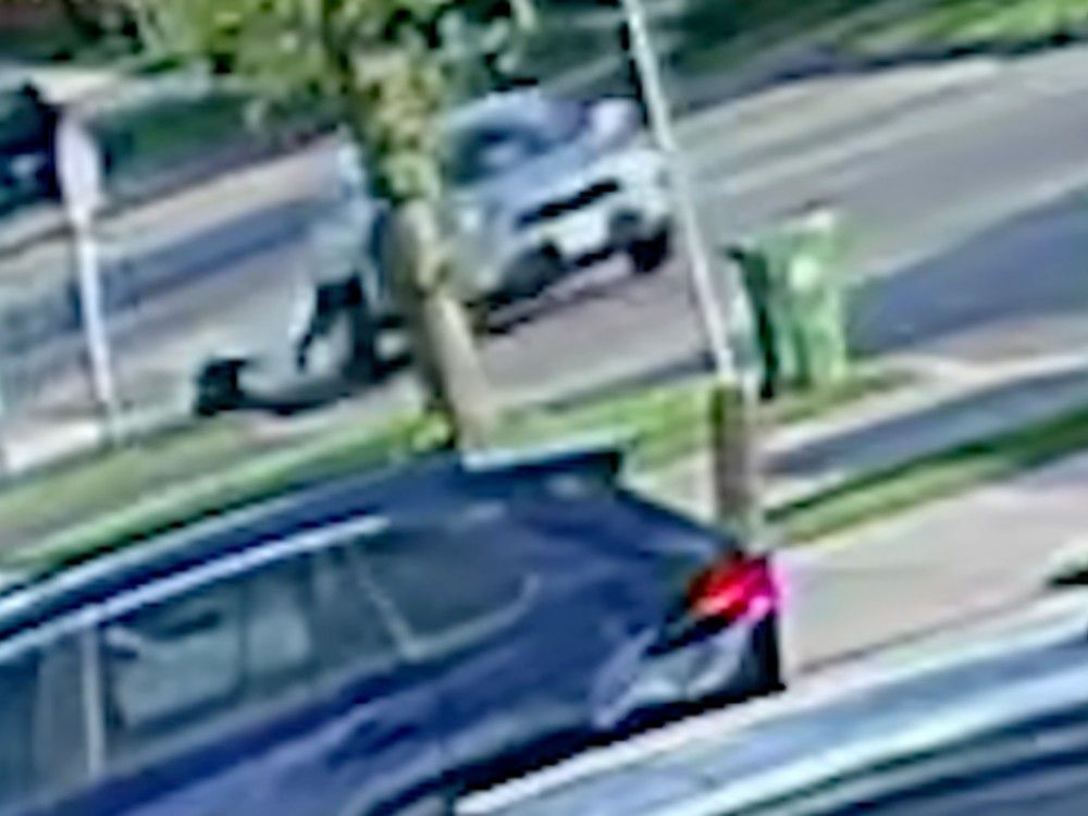  A victim of distraction theft is seen being dragged by a vehicle in front of their home on a residential street in this still image taken from a video shared by Toronto police. Suspects tried to take the victim’s necklace, but when the victim pulled away, a struggle ensued.