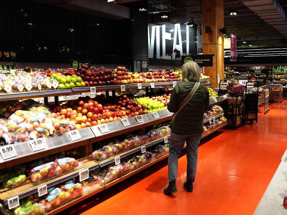 A customer looks for produce at a grocery store in Ottawa, on Wednesday, April 2, 2025.