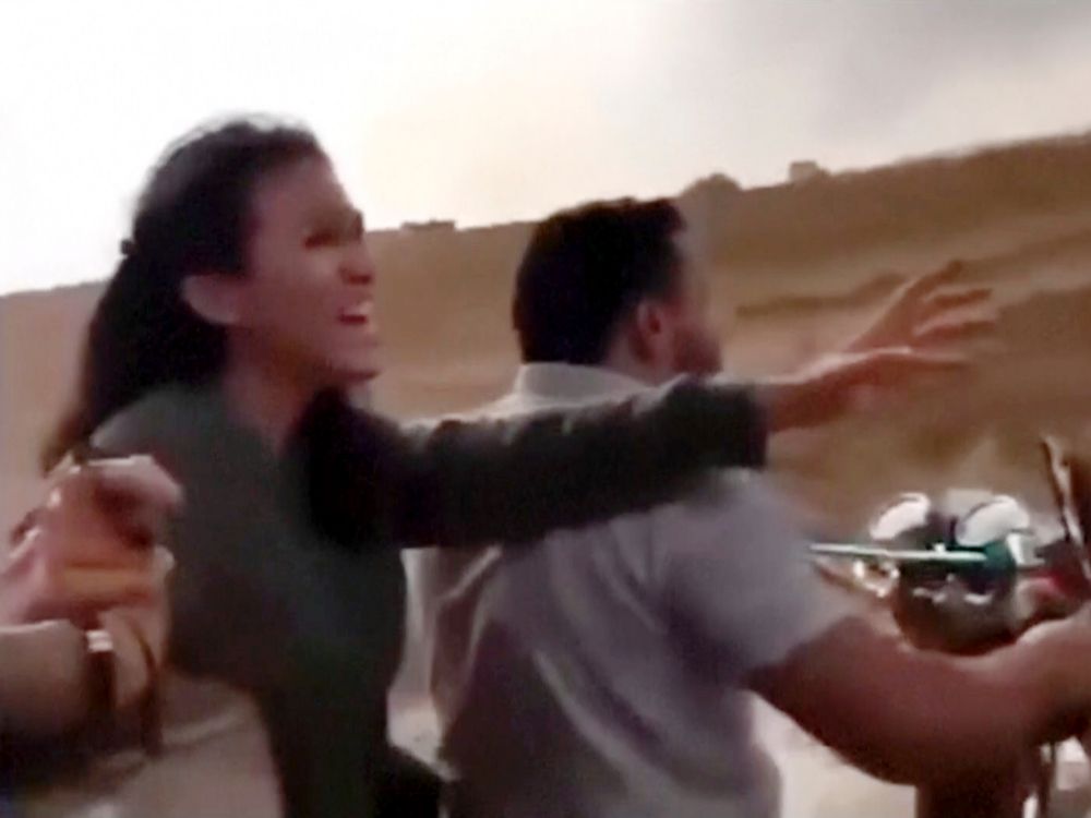  In this image from video obtained by the AP, Noa Argamani reacts as she and her partner Avinatan Or, not pictured, are seized by members of Hamas during an incursion into Israel on Oct. 7, 2023.