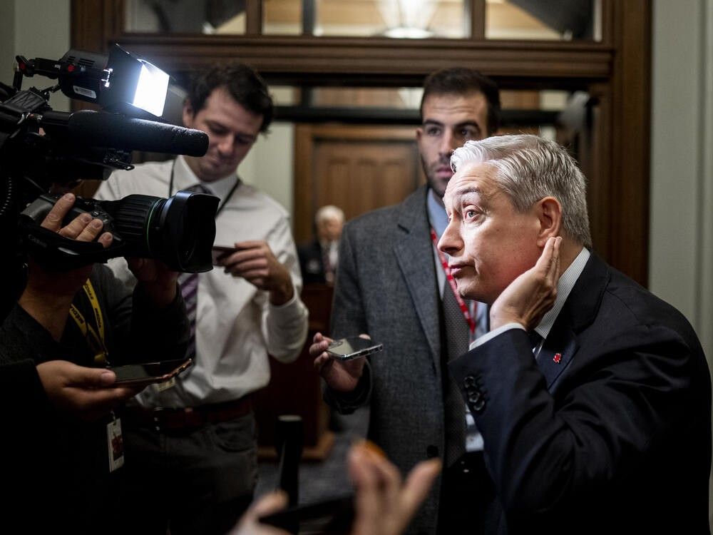 Minister of Finance and National Revenue Francois-Philippe Champagne listens to a reporter's question ahead of a cabinet meeting on Parliament Hill in Ottawa, on Tuesday, Oct. 21, 2025.