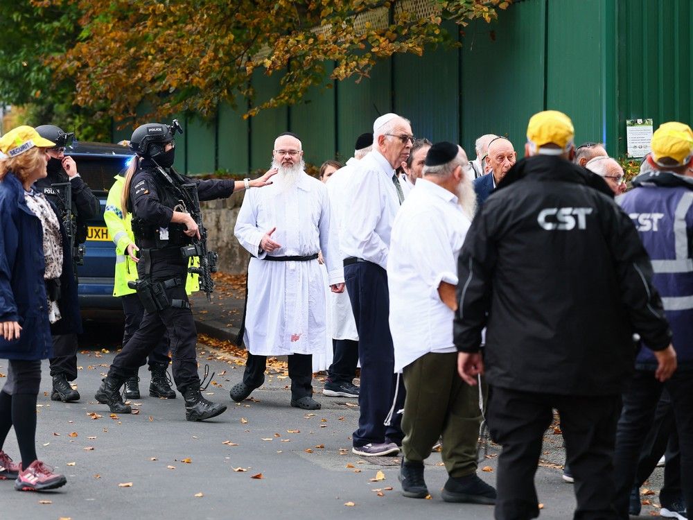 Armed police officers talk with members of the community near Heaton Park Hebrew Congregation synagogue in Crumpsall, north Manchester, on Oct. 2, 2025, following an incident at the synagogue. Armed police officers talk with members of the community near Heaton Park Hebrew Congregation synagogue in Crumpsall, north Manchester, on Oct. 2, 2025, following an incident at the synagogue.